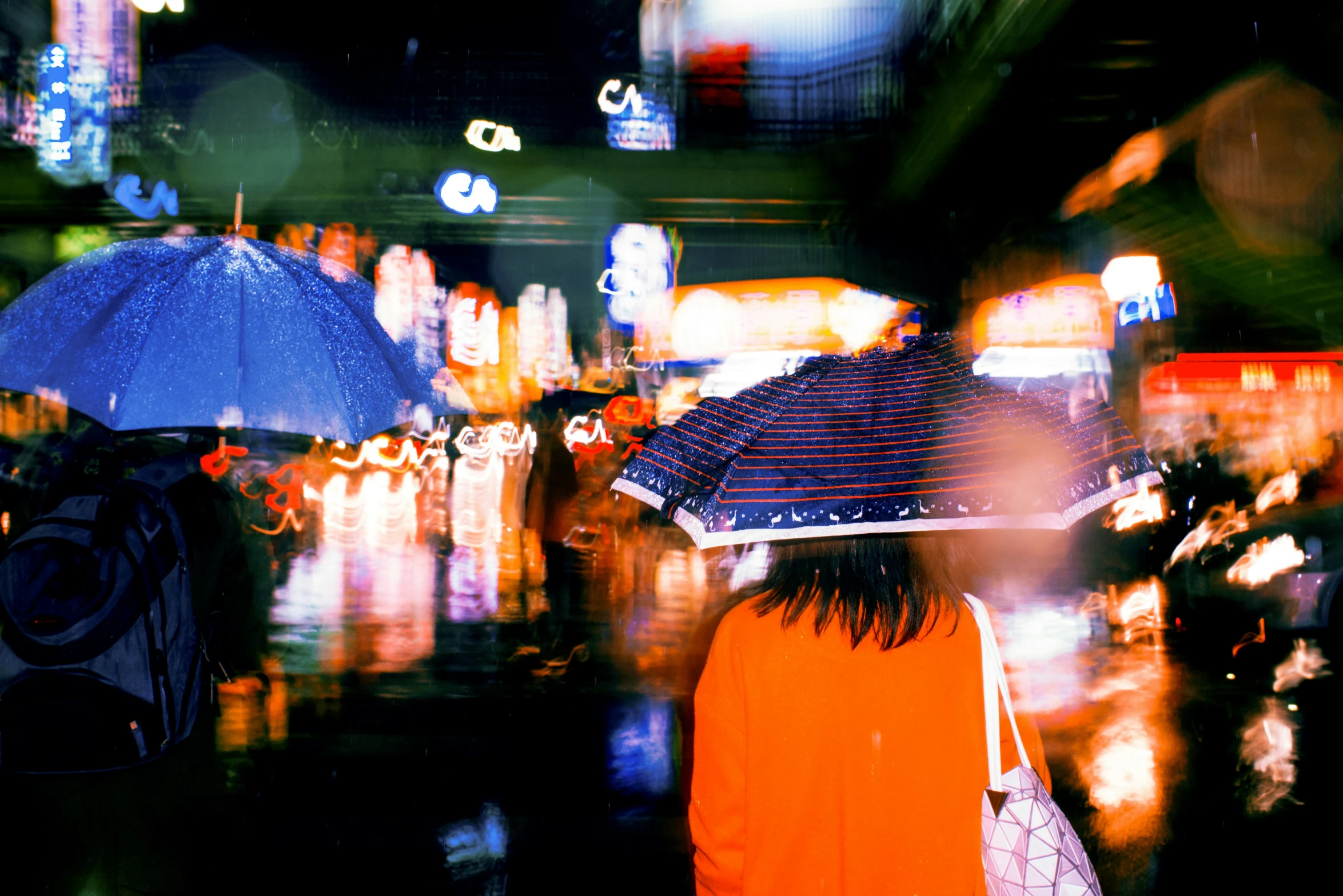 a group of people with umbrellas in the rain