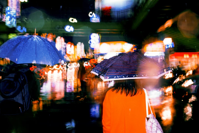 a group of people with umbrellas in the rain