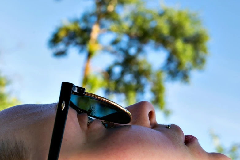 a child wearing glasses with his eyes slightly closed