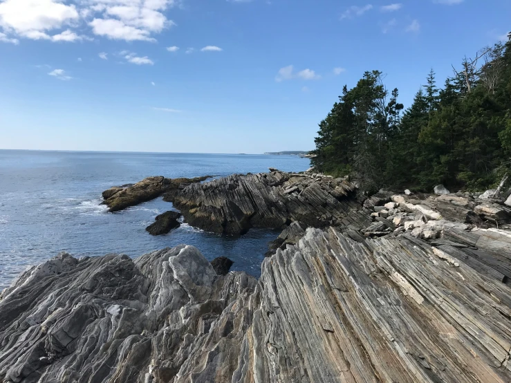 a beach with waves coming in from the shore and lots of rocks