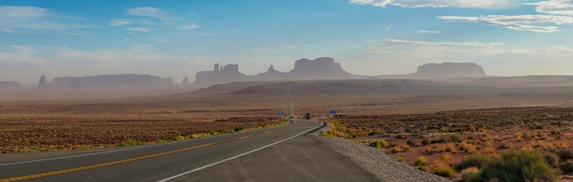 an empty road in the desert is seen