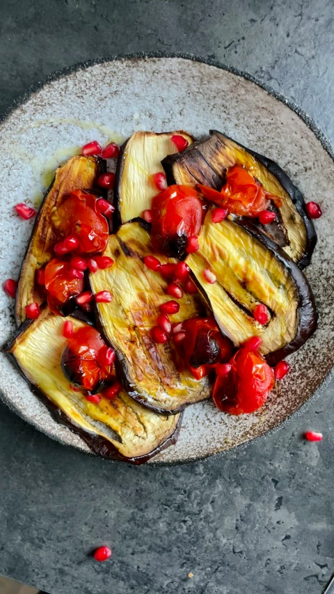 a plate with some banana and tomato toppings on it