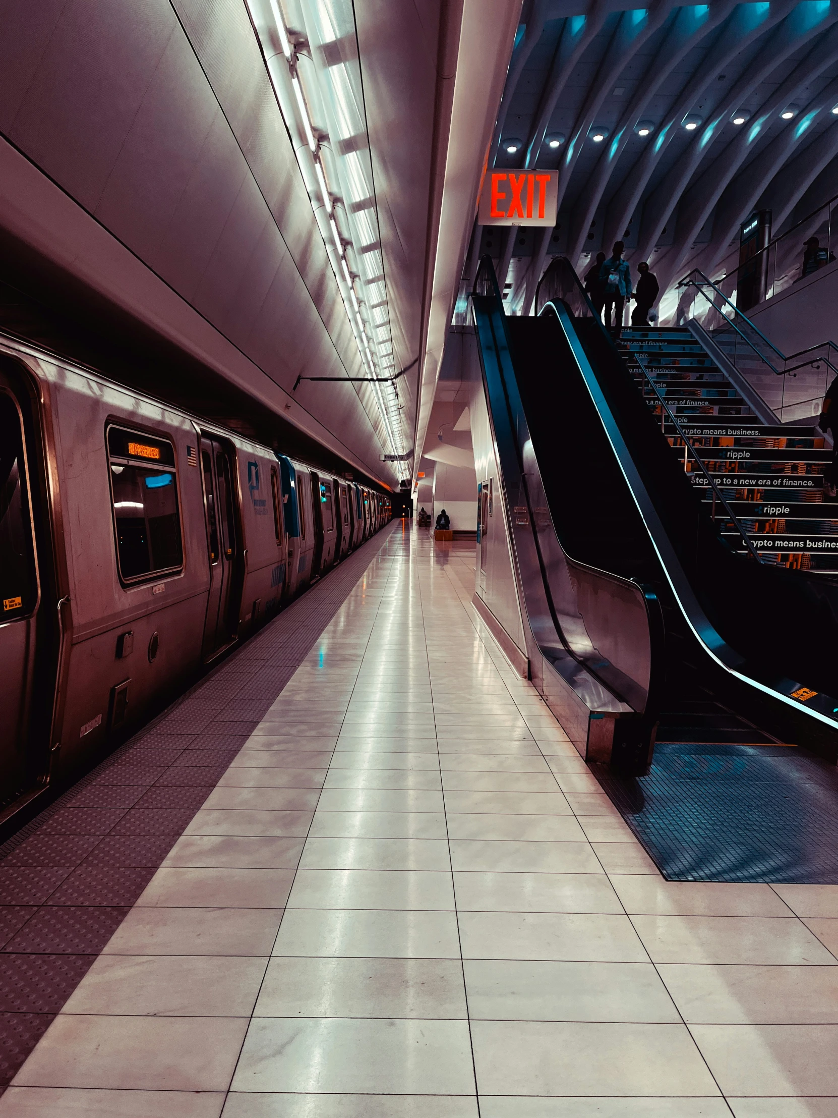 people standing on an escalator in an indoor station