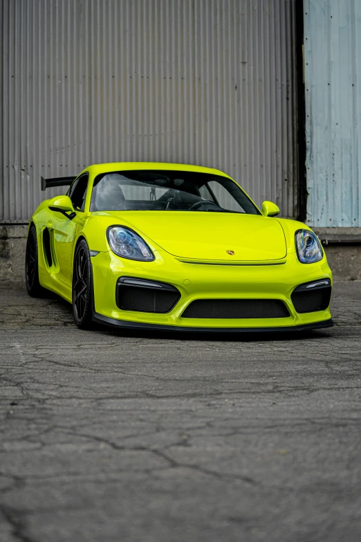 a bright yellow car parked in a parking lot