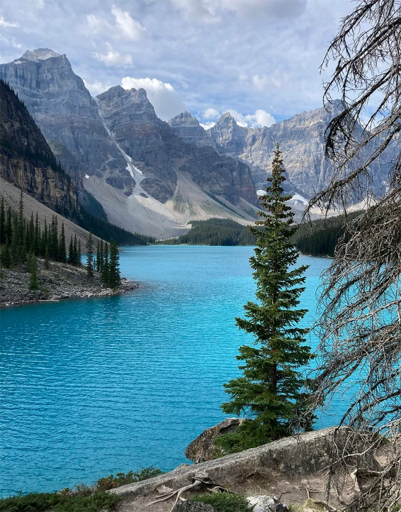 a mountain lake with blue water, and trees around