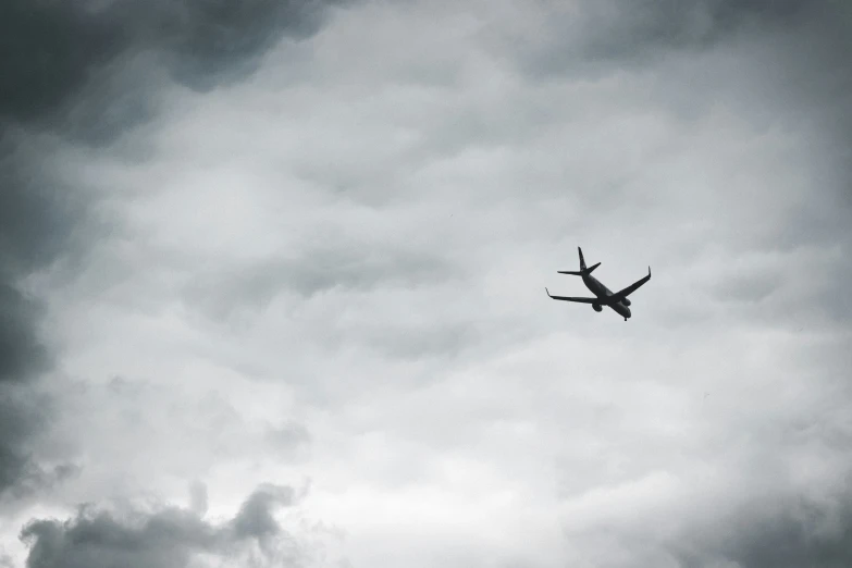 a black and white pograph of an air plane flying through the sky