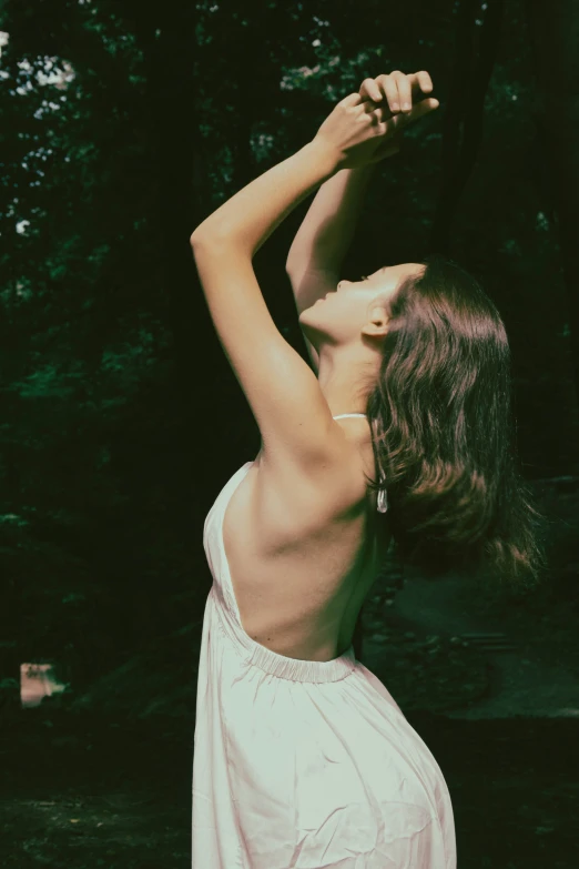 a  young lady practicing yoga in the woods