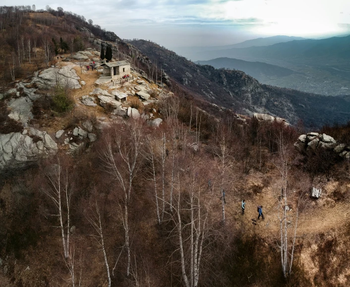 a group of people hiking up a rocky hill with a view