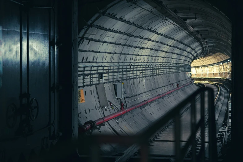 an old subway station with a train pulling up to the underground