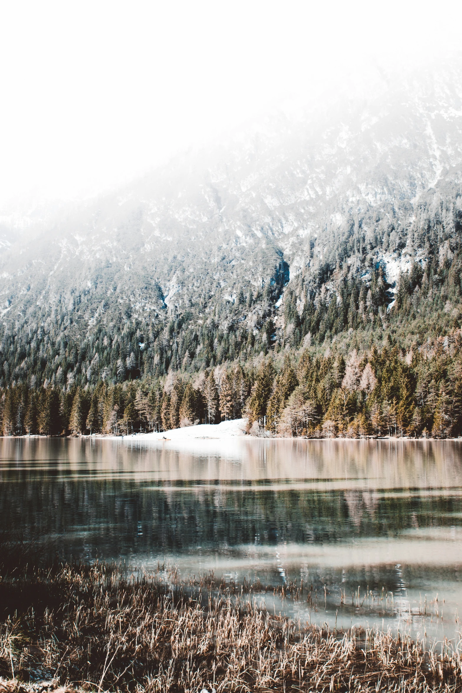 there is a lake and hills covered in snow