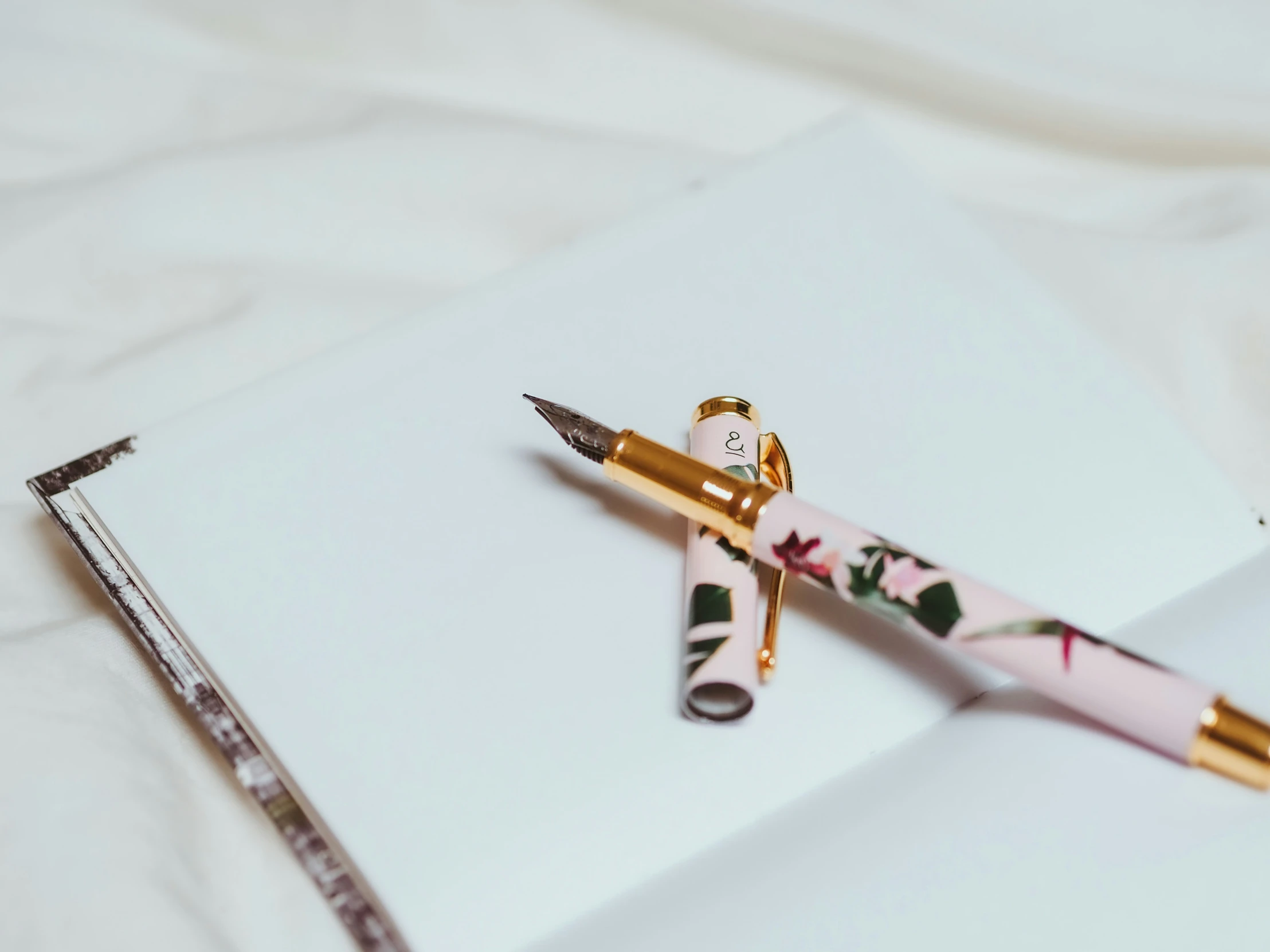 a pen laying on top of a white piece of paper