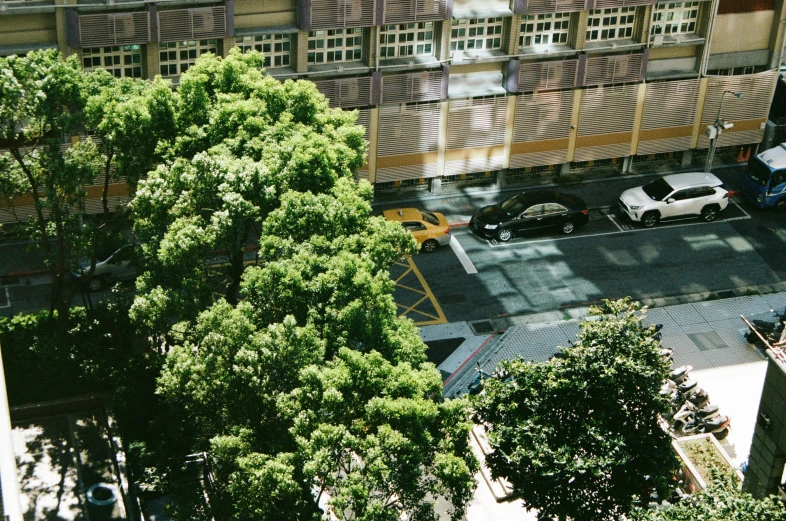 a parking lot and some trees in front of buildings