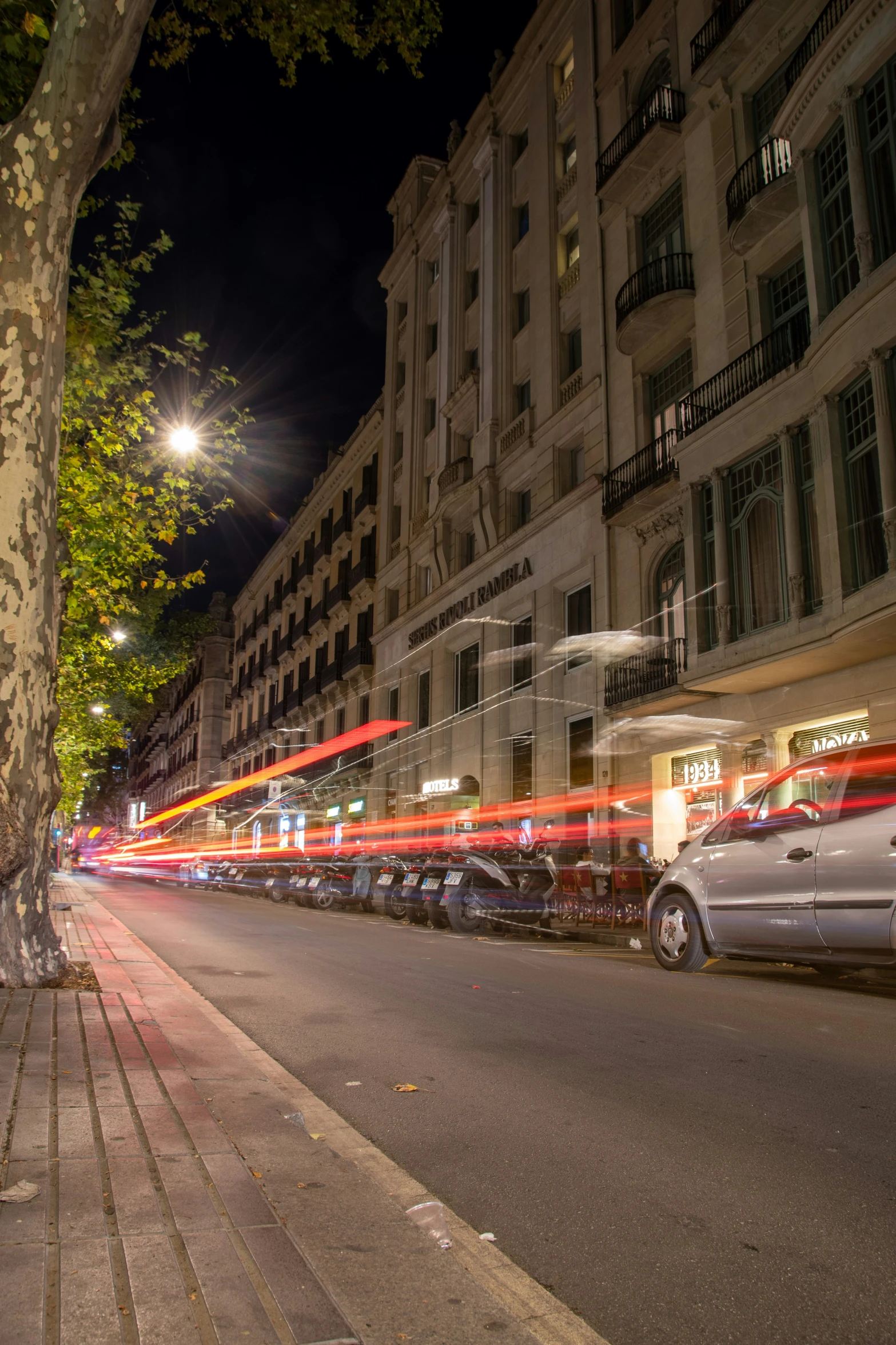 the car lights streak down the city street