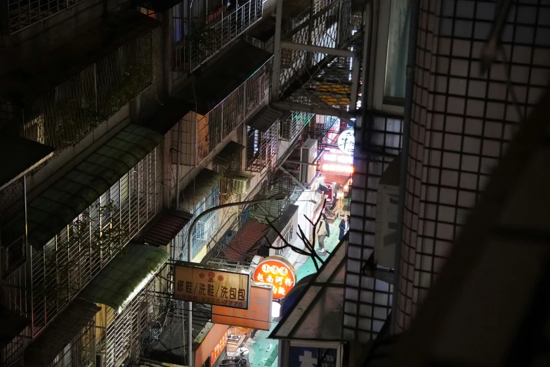 an urban building filled with shops and a few people walking