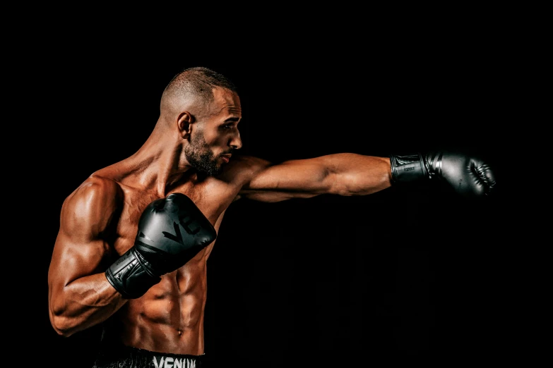 a man with a black hair is holding his arms out and facing the camera