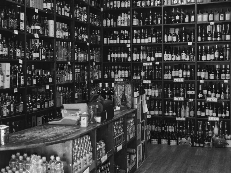 the interior of an alcohol store with a big wall of bottles and bottles