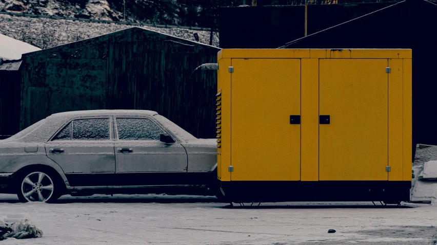 a small yellow box sitting on the sidewalk