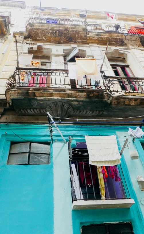 there is some clothes hanging out on the balcony