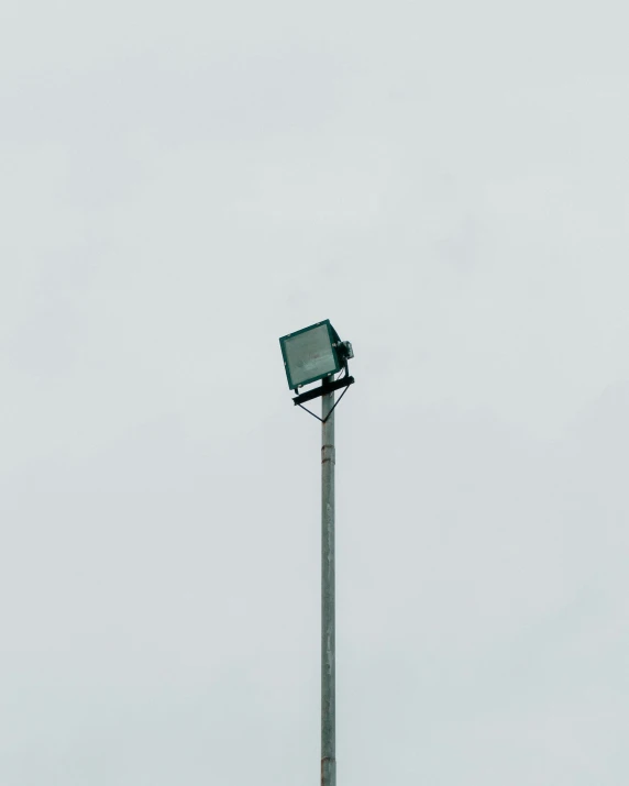 a street light with a green box attached to it