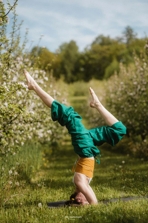 the man is practicing yoga in the park