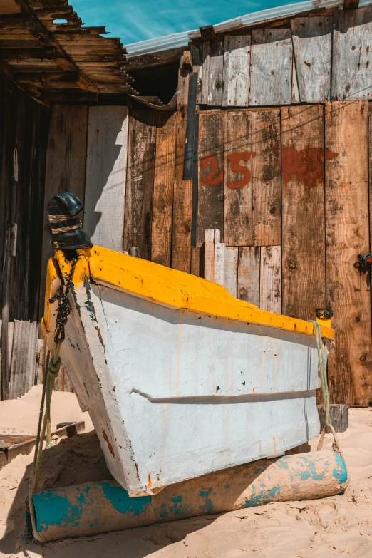 an old white boat is sitting in front of an old building