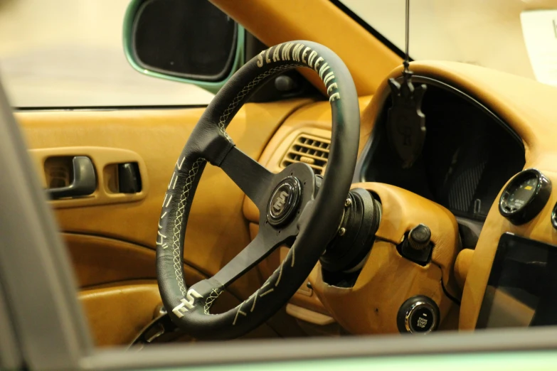 a brown dashboard with a steering wheel and a tan interior