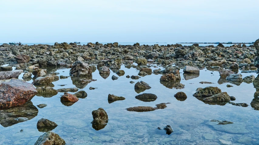 rocks in the water near large boulders