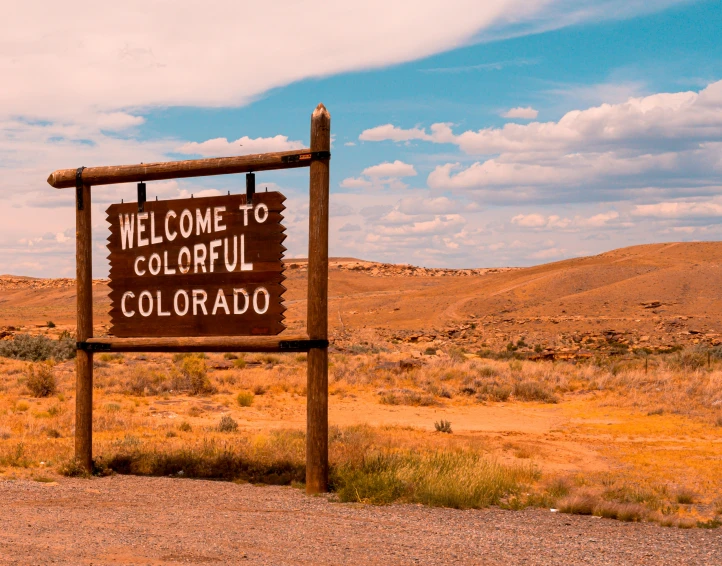a welcome sign to colorful colorado on the desert