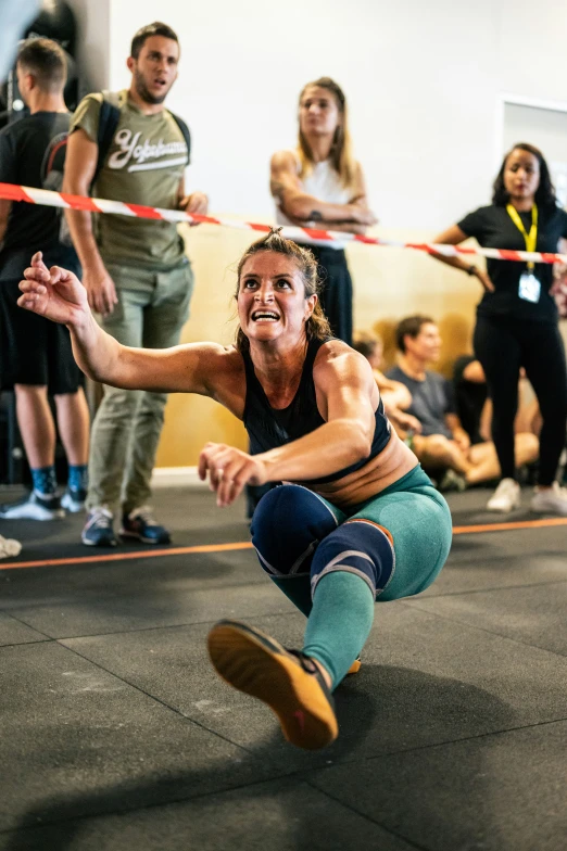 a woman is in mid air performing a trick on a skateboard