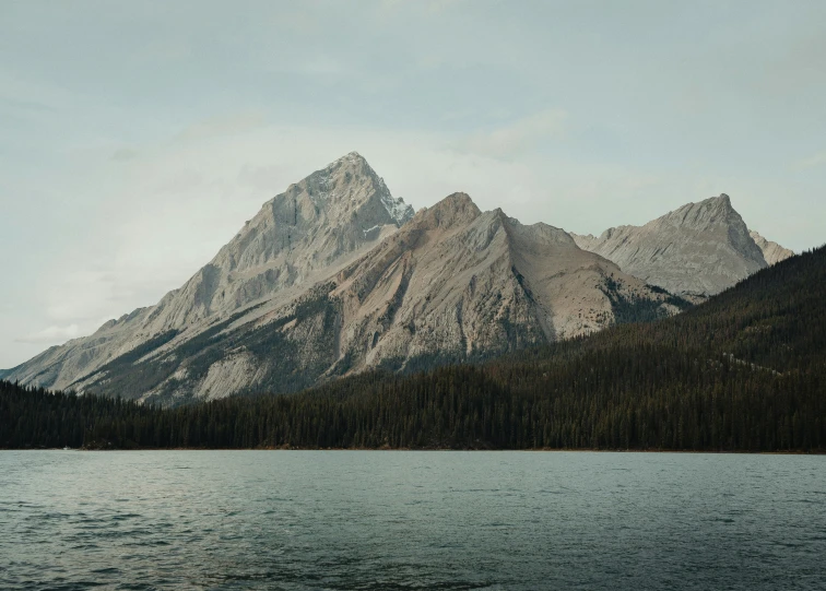 the mountain range is set above water and trees