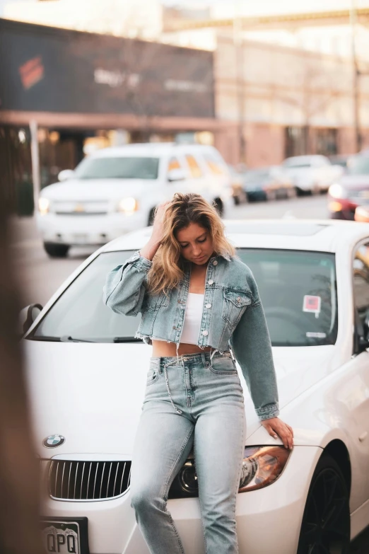 a person leaning on a car in the street