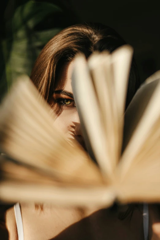 the book is open and the woman's face is blurred