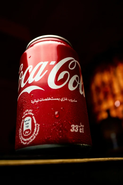 a can of coca - cola sits on a table