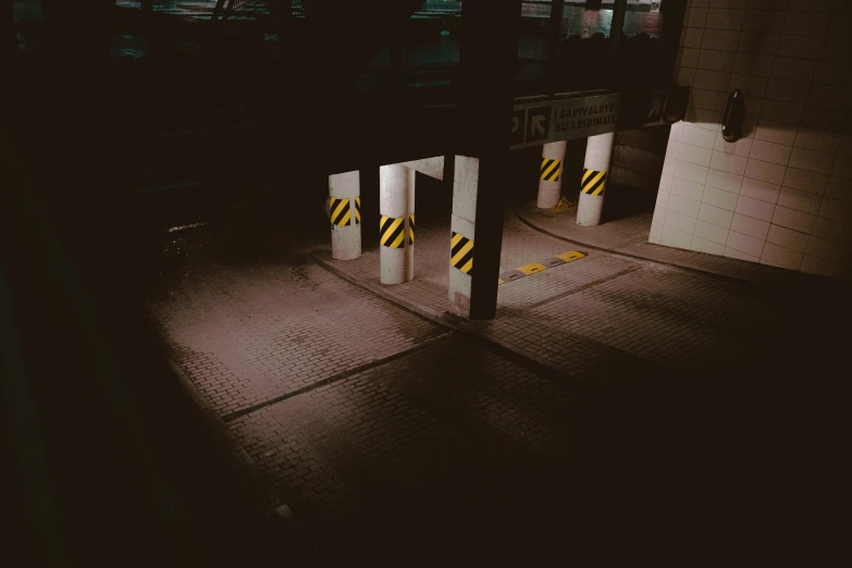 a couple of white poles sitting in the middle of a parking lot