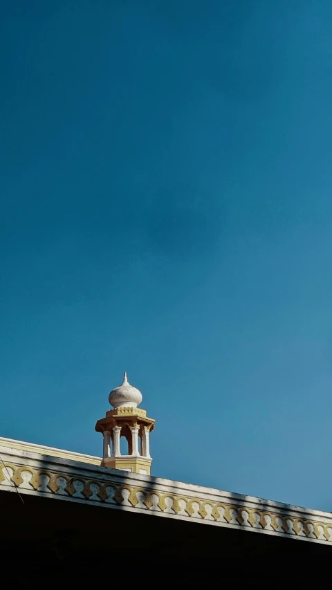 an airplane flies over the top of a building