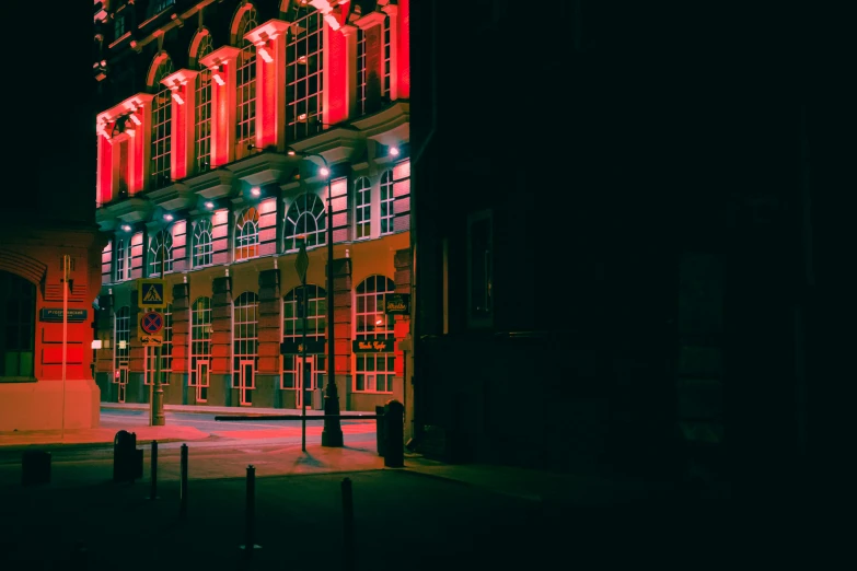 a large red building has many lit windows