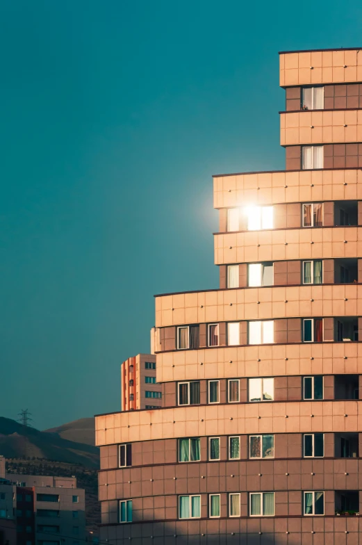 this po shows a building with many windows and the sun peeking through