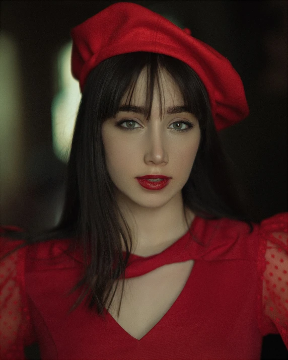 a woman with a red hat posing for the camera