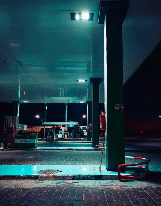 a gas station with a red wagon parked at the front