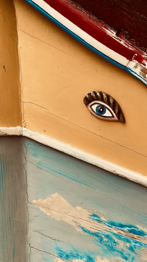 an eye appears through the center part of a boat