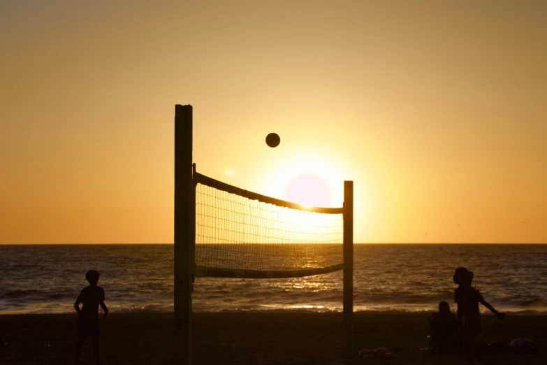 volleyball net sitting at the beach at sunset