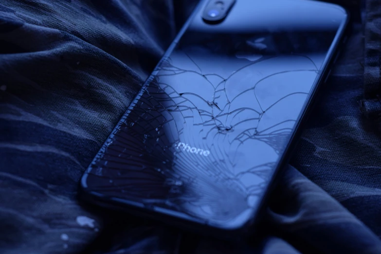 a samsung phone with broken glass on it