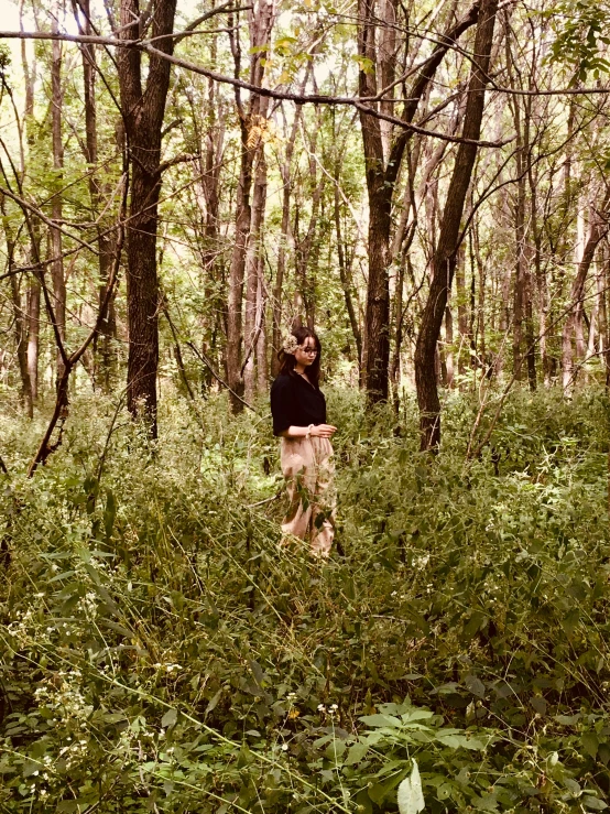 a man standing in the woods with his dog