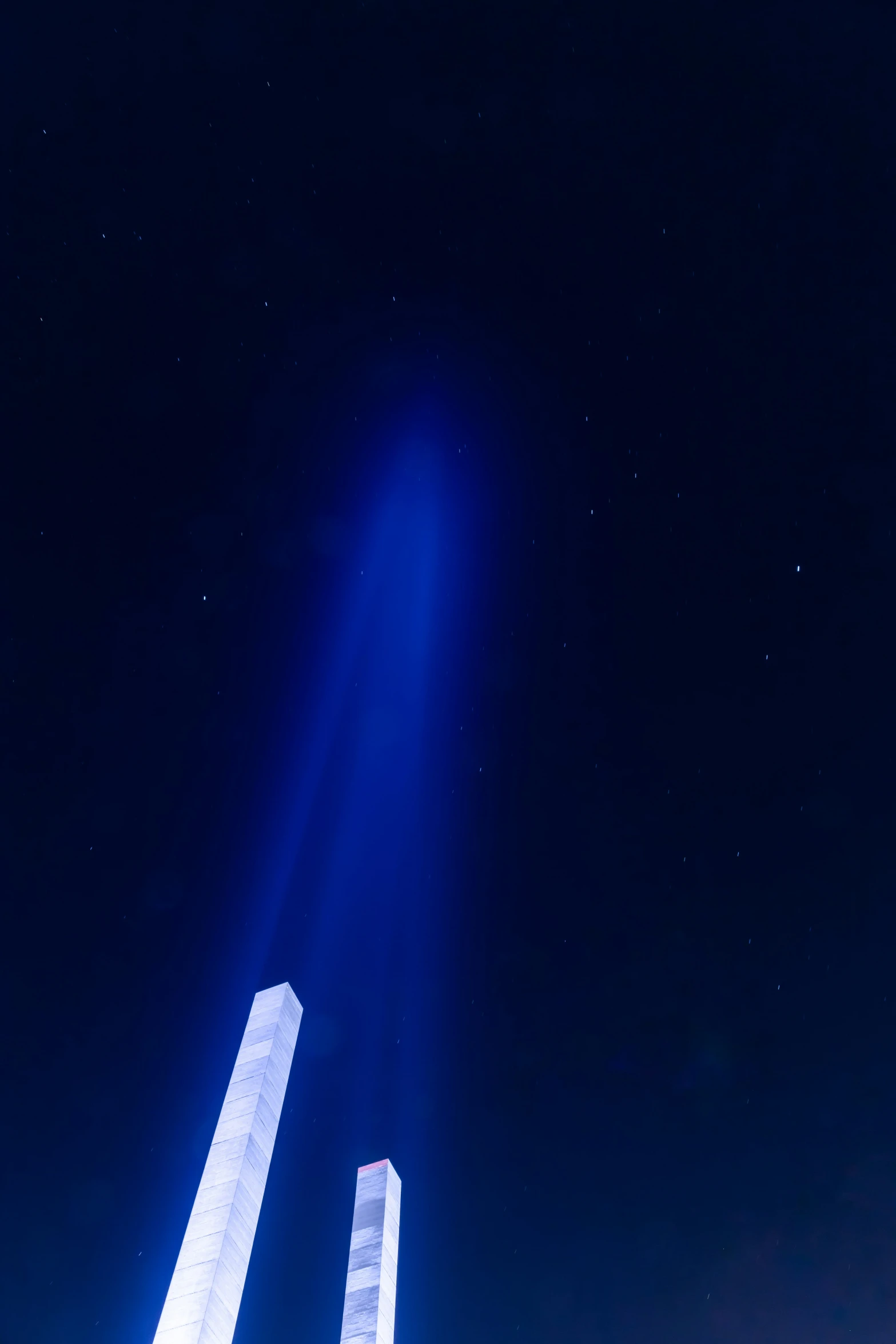 a group of blue lights are glowing in the night sky