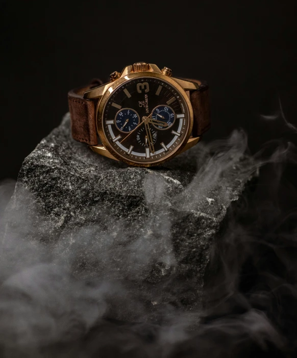 a watch on top of a rock near smoke