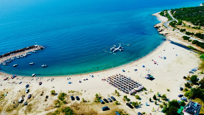 the beach has many cars and boats on it