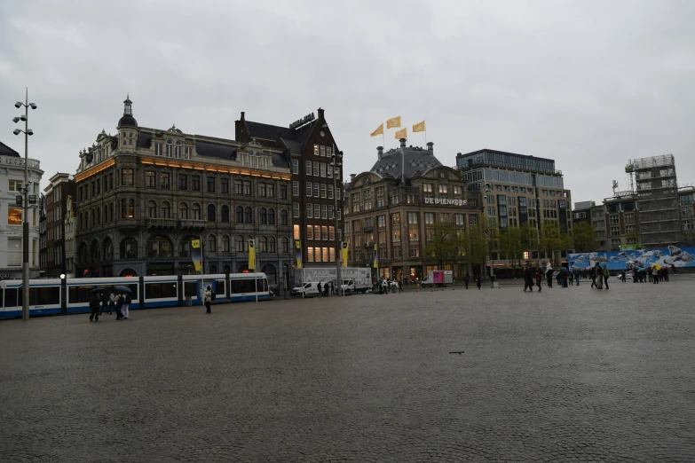 buses parked outside a building in the middle of a city