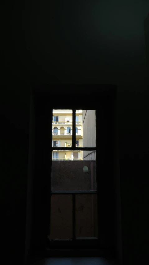 a small window with some buildings outside