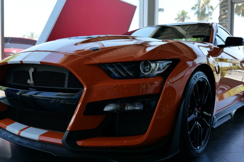 a mustang car is parked inside a showroom