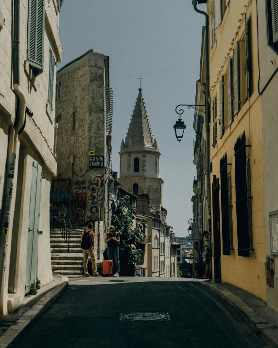 an image of two people walking in the street